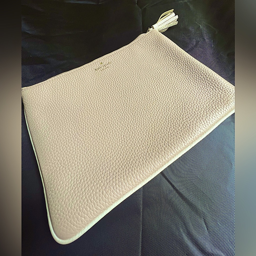 Beige leather Kate Spade clutch with tassel.